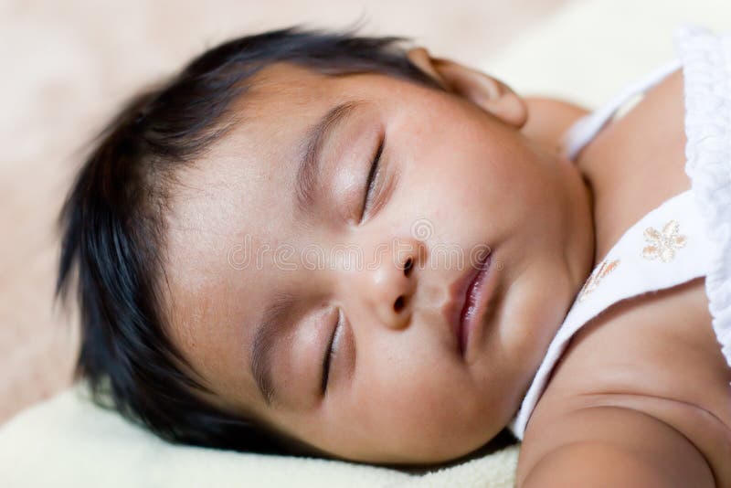 Infant sleeping on the back in a safe cot